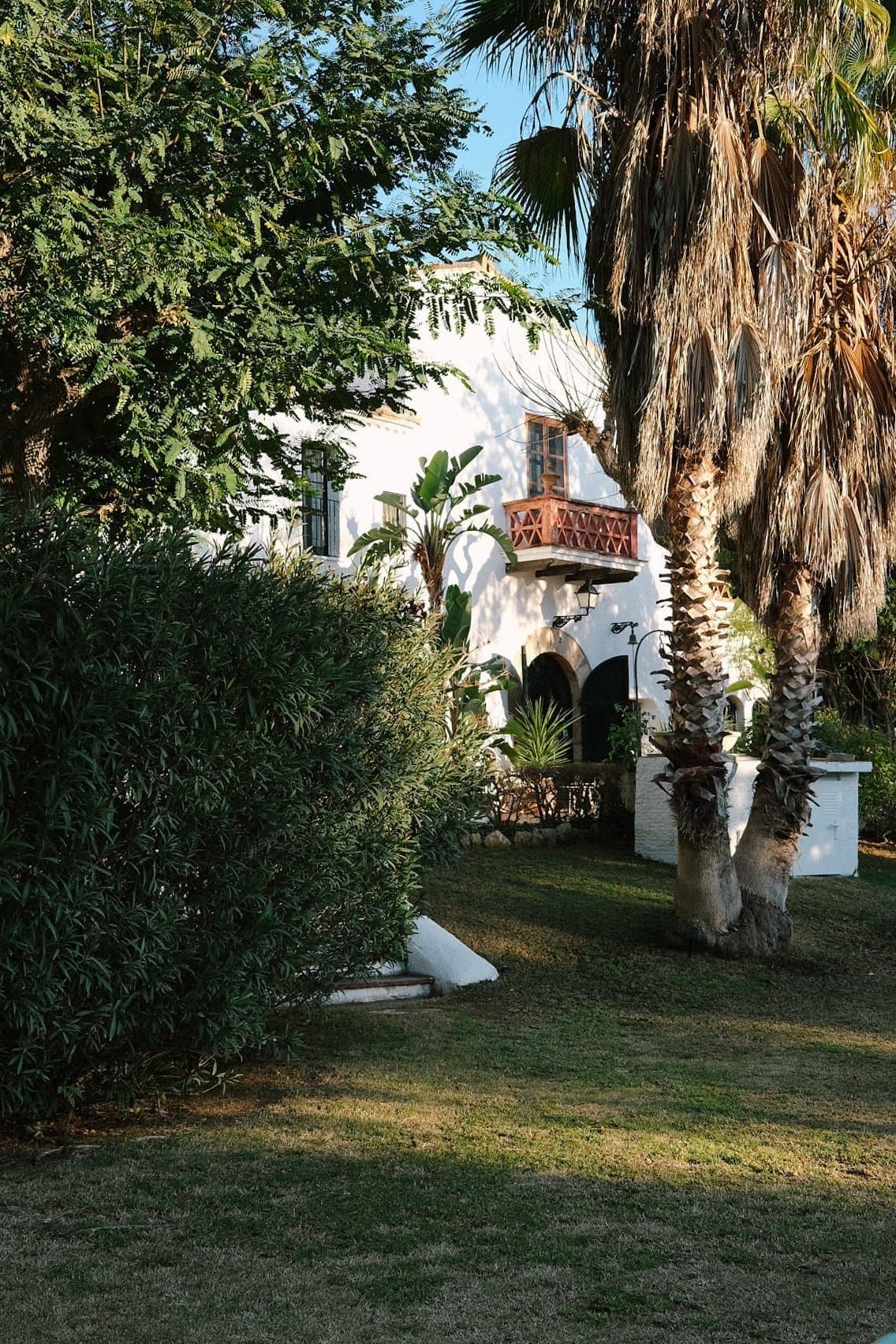 Whitewashed Spanish-style facade of Masia Can Pares with arched entrance