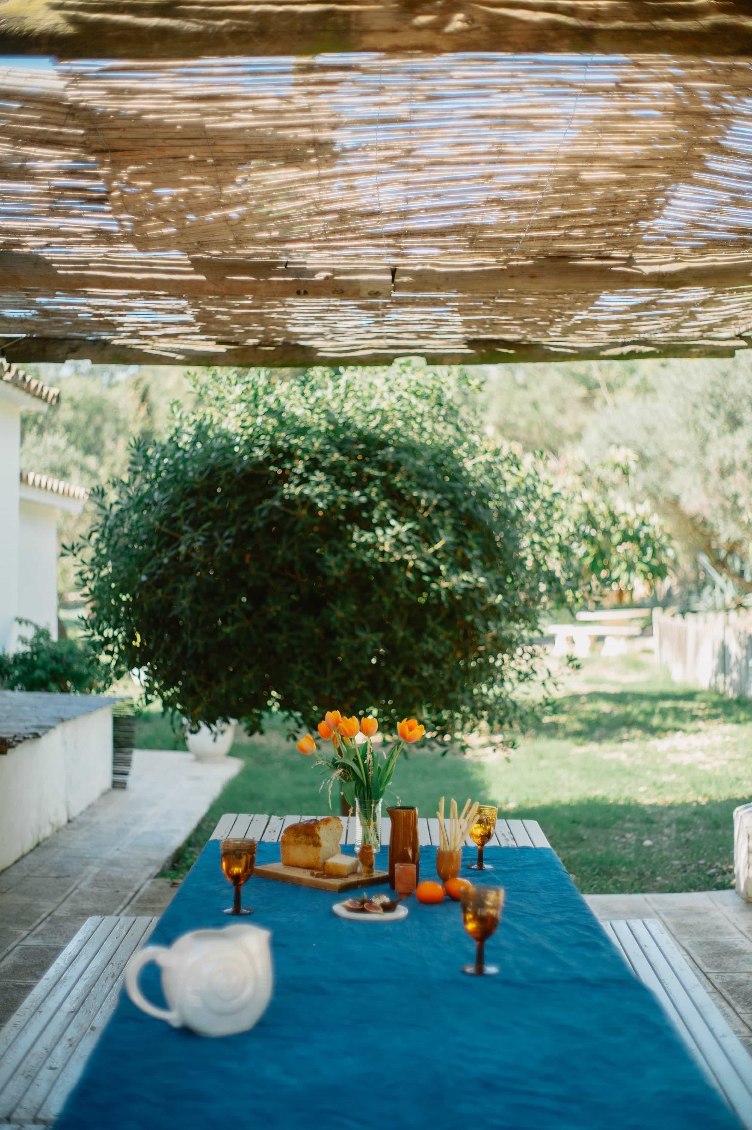 Outdoor dining table set in the botanical garden of Masia Can Pares